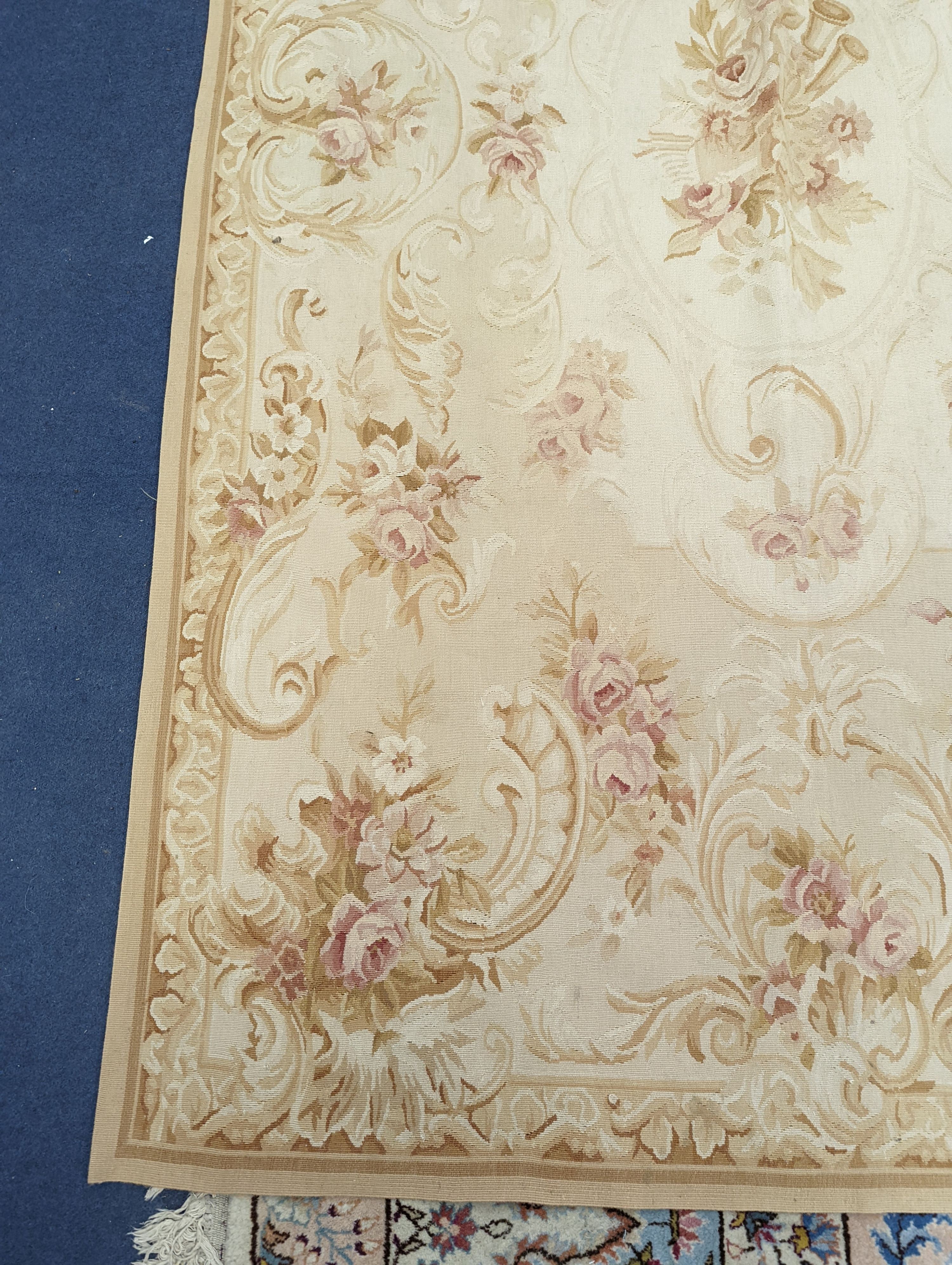 An Aubusson gold ground rug with rose pattern, 244 x 153cm